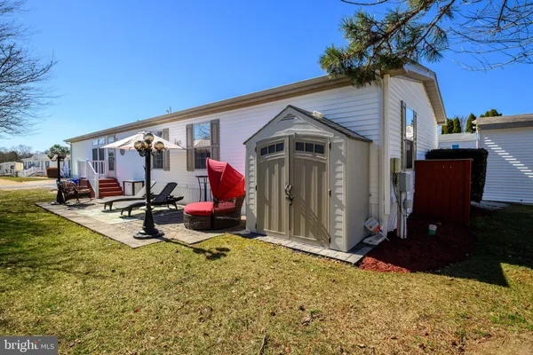 a view of a house with backyard porch and sitting area