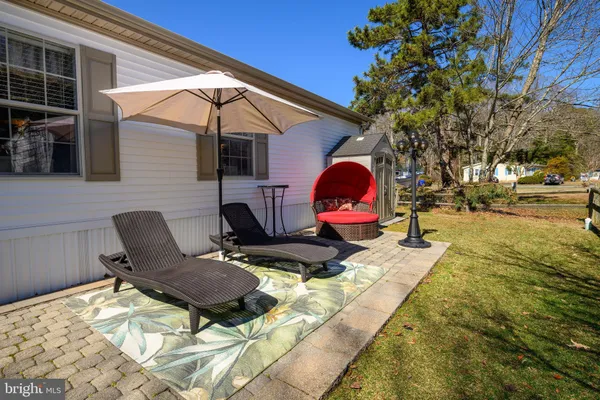 a backyard of a house with barbeque oven table and chairs
