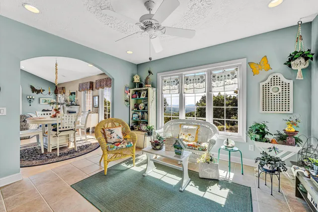 a view of a patio with table and chairs potted plants with lake view