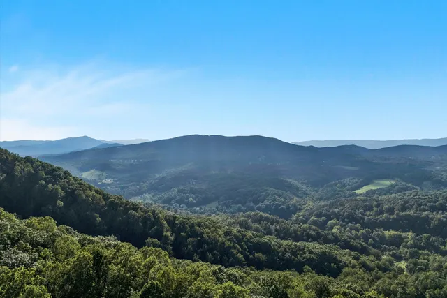 a view of a dining room with furniture large windows and wooden floor