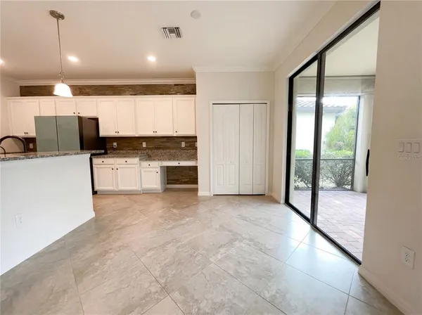 a view of a kitchen with a sink and cabinets
