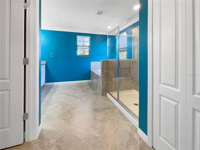 a view of a bathroom with a tub and shower