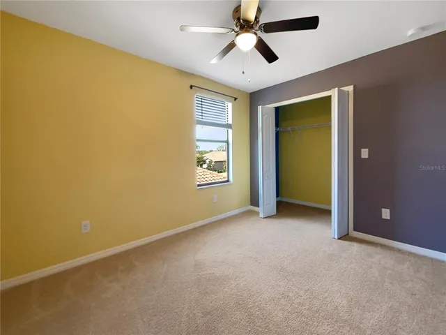 a view of empty room with ceiling fan