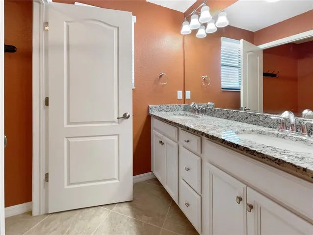 a bathroom with a toilet and white tub