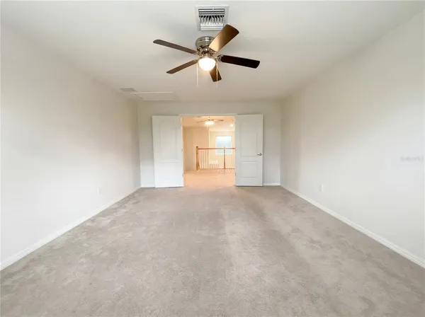 a view of a livingroom with a ceiling fan and window