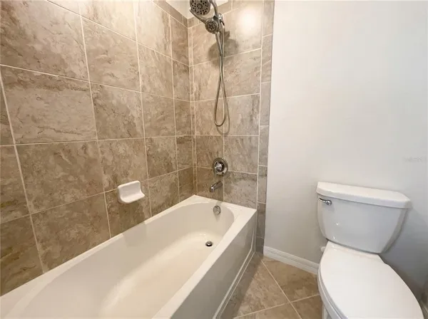 a bathroom with a toilet and shower