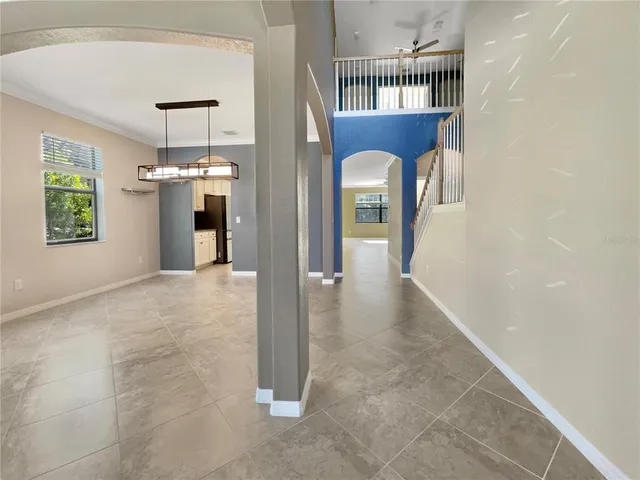 a view of a hallway with wooden shelves and chandelier
