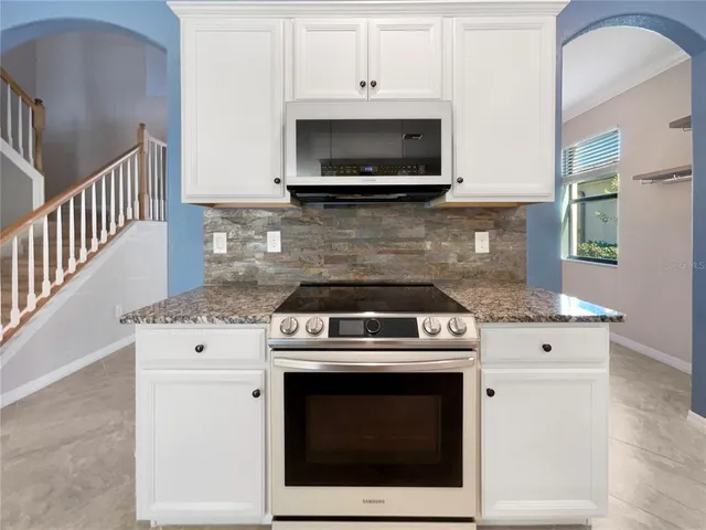 a stove top oven sitting inside of a kitchen