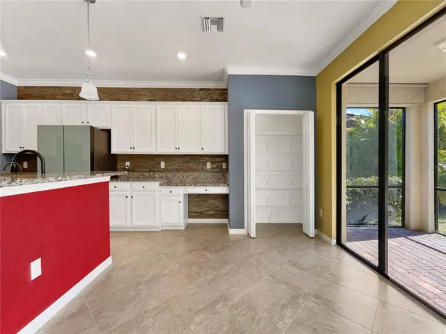 a kitchen with stainless steel appliances kitchen island granite countertop a refrigerator and a stove top oven