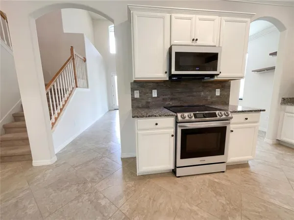 a kitchen with a stove and a microwave