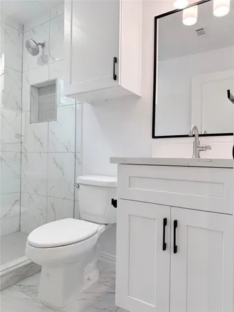 a white toilet sitting next to a bathroom sink