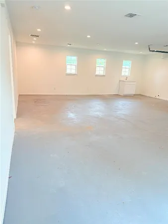 a view of empty room with wooden floor and cabinet