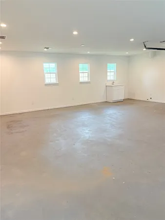 an empty room with a empty space and windows