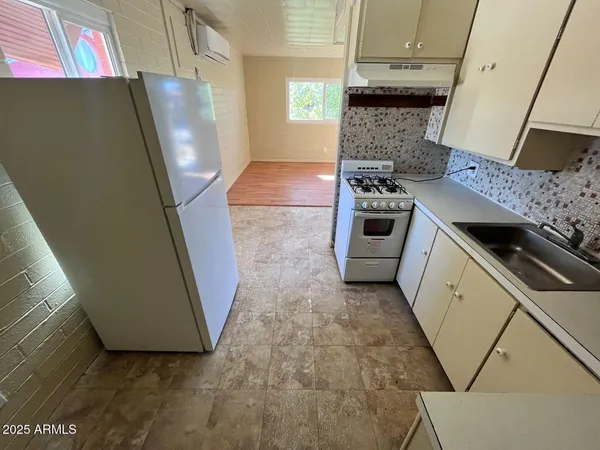 a kitchen with a stove and a refrigerator