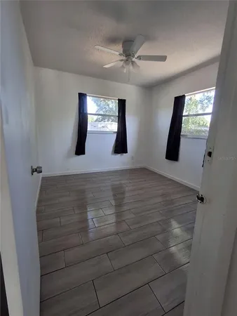 a view of room with window and hardwood floor