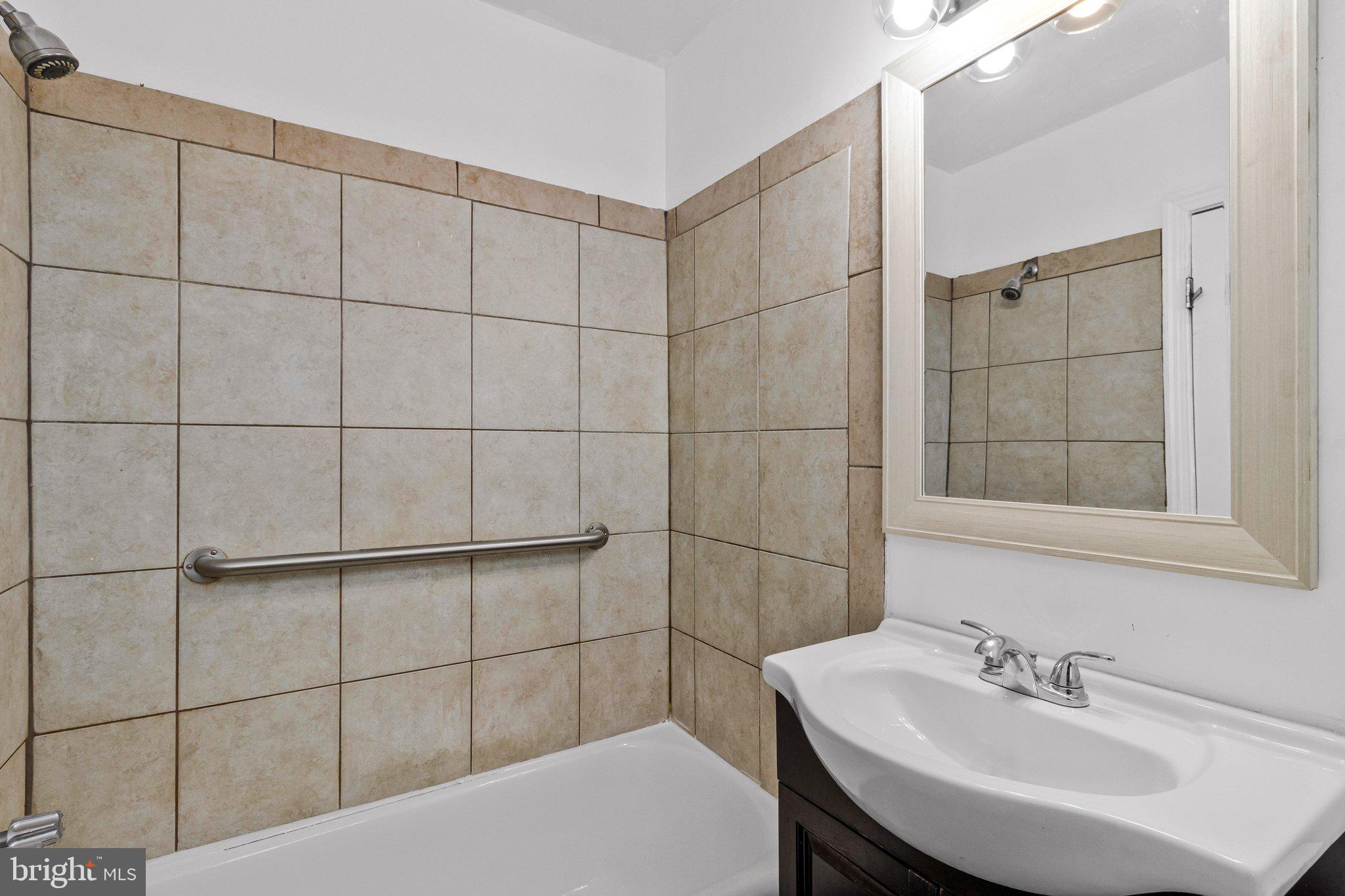 4834-4836 Sheriff Road Northeast Washington, DC 20019 - Photo 15 of 18 a bathroom with a sink and shower