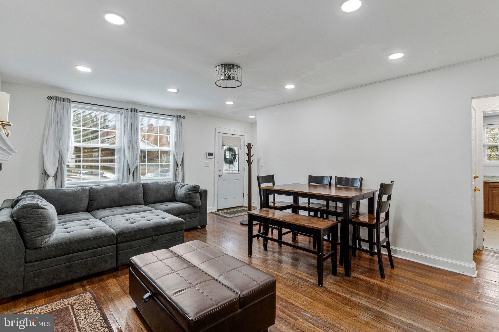 4834-4836 Sheriff Road Northeast Washington, DC 20019 - Photo 2 of 18 a living room with furniture a wooden floor and a window