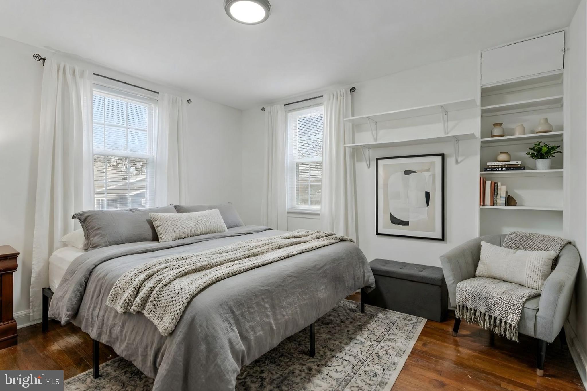 4834-4836 Sheriff Road Northeast Washington, DC 20019 - Photo 4 of 18 a bedroom with a bed and a couch