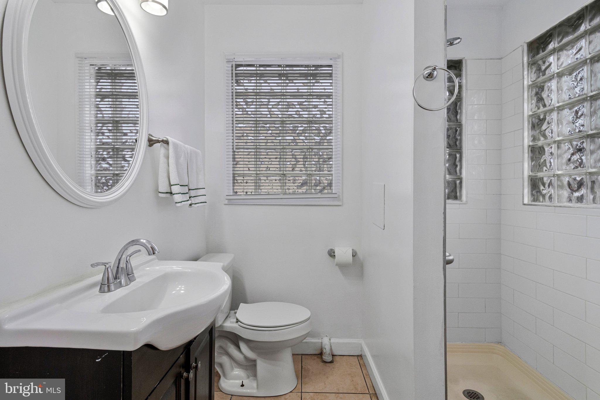 4834-4836 Sheriff Road Northeast Washington, DC 20019 - Photo 7 of 18 a bathroom with a sink toilet and shower