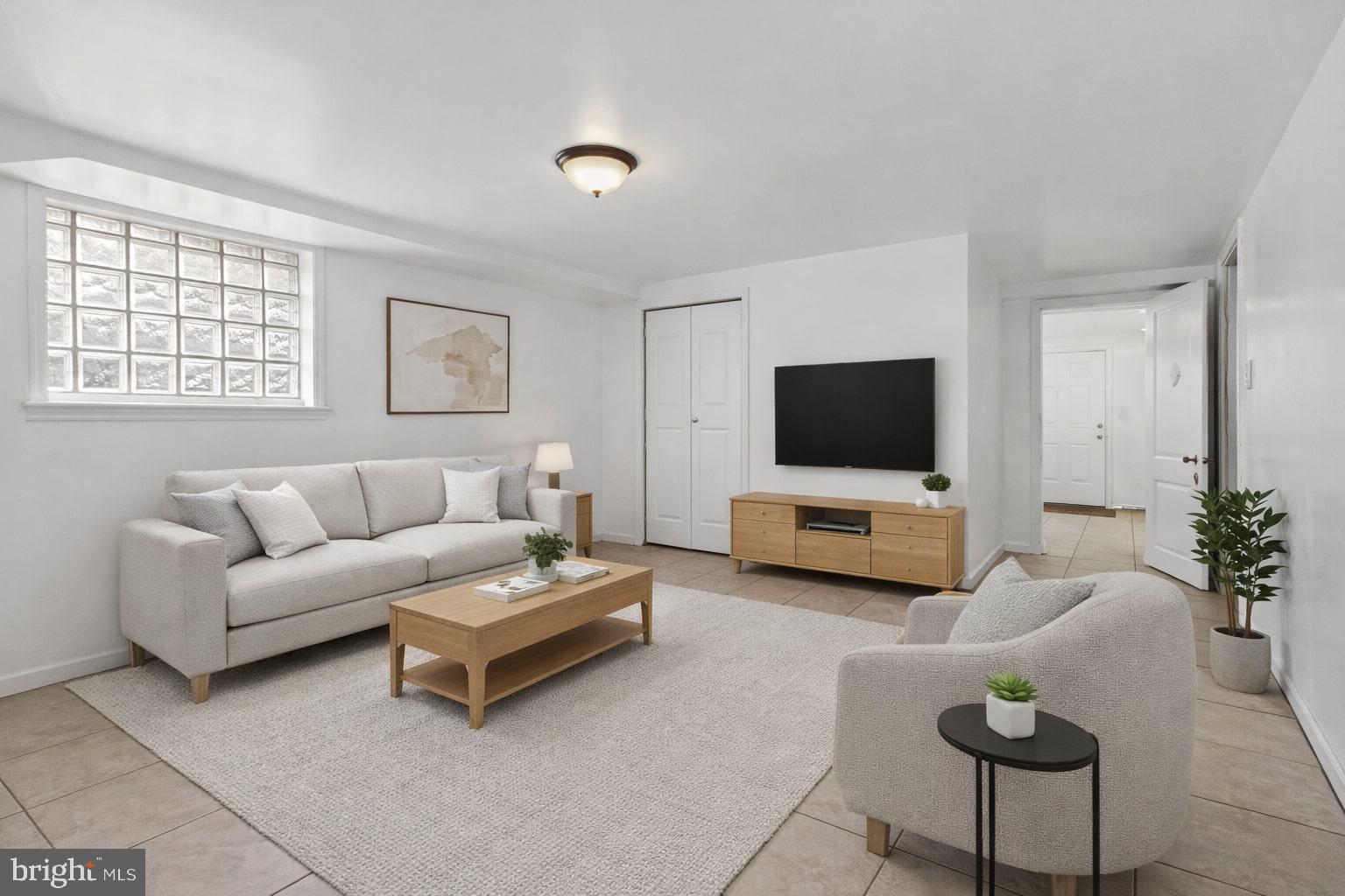 4834-4836 Sheriff Road Northeast Washington, DC 20019 - Photo 8 of 18 a living room with furniture and a flat screen tv