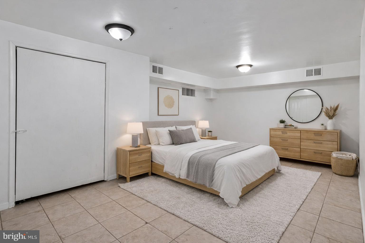 4834-4836 Sheriff Road Northeast Washington, DC 20019 - Photo 9 of 18 a bedroom with a bed mirror and window