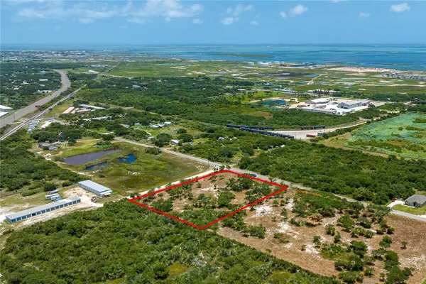 a view of a field with an ocean