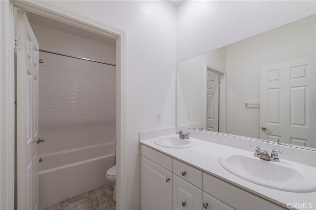 7309 Grazing Lane Riverside, CA 92507 - Photo 14 of 43 a bathroom with a sink toilet double vanity and shower