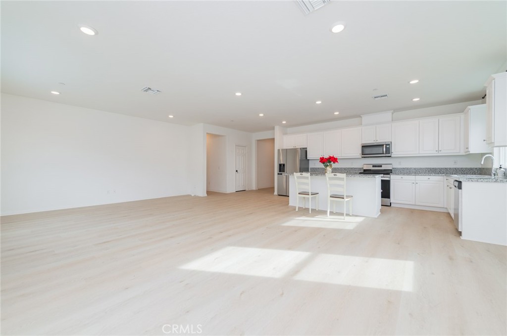 7309 Grazing Lane Riverside, CA 92507 - Photo 22 of 43 a kitchen with stainless steel appliances granite countertop a sink and cabinets
