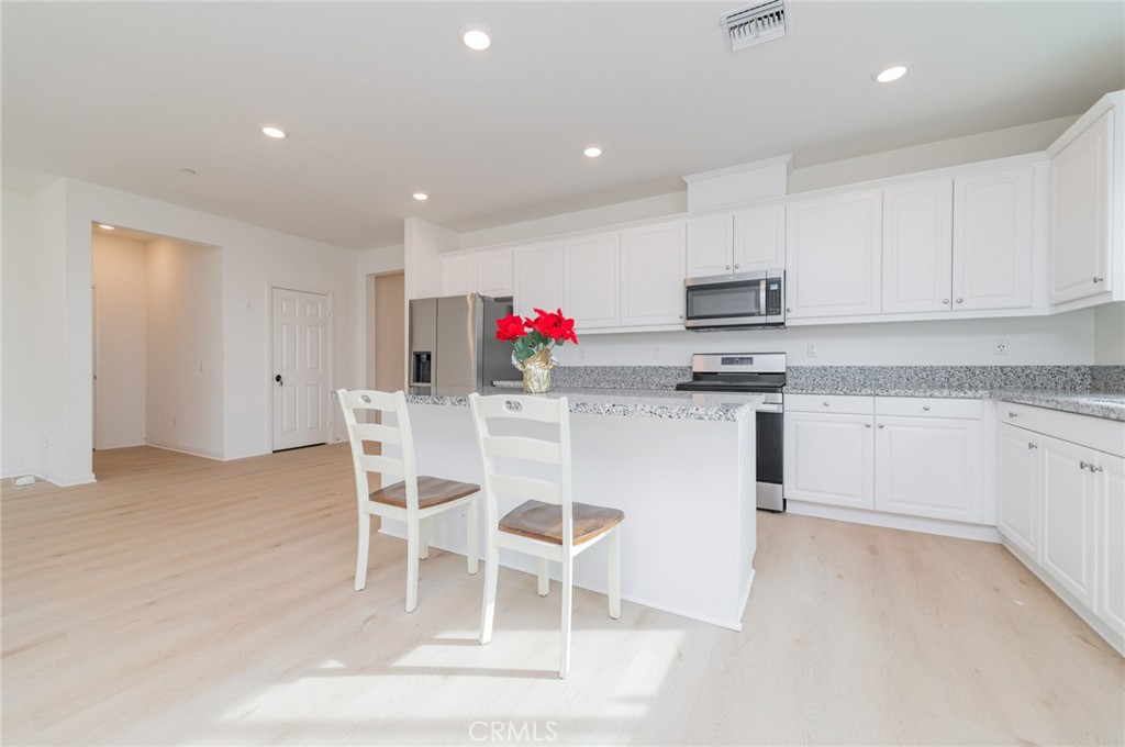 7309 Grazing Lane Riverside, CA 92507 - Photo 23 of 43 a kitchen with granite countertop cabinets and chair