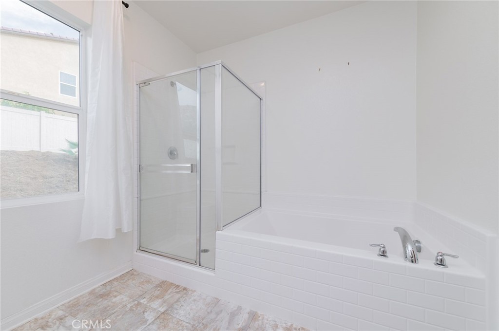 7309 Grazing Lane Riverside, CA 92507 - Photo 34 of 43 a bathroom with a bathtub and a shower