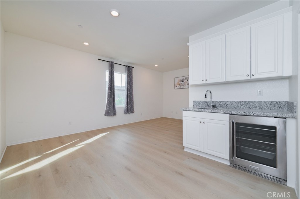 7309 Grazing Lane Riverside, CA 92507 - Photo 7 of 43 a kitchen with granite countertop white cabinets and white appliances
