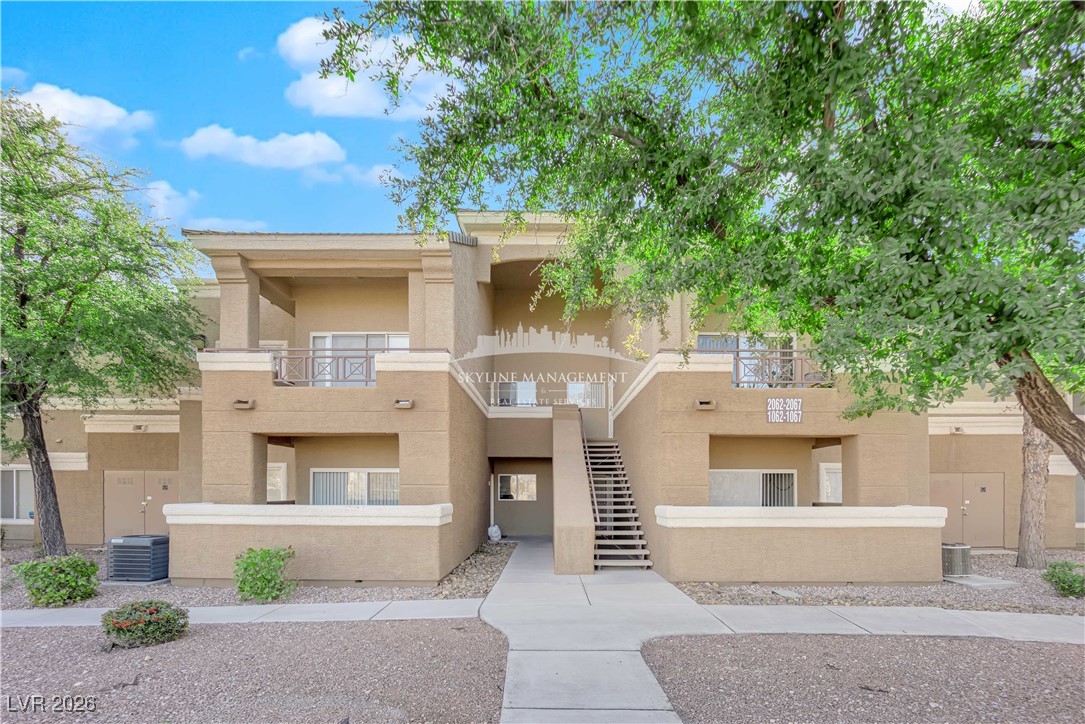 8070 West Russell Road, Unit 2063 Las Vegas, NV 89113 - Photo 2 of 31 View of apartment building / complex featuring stairway