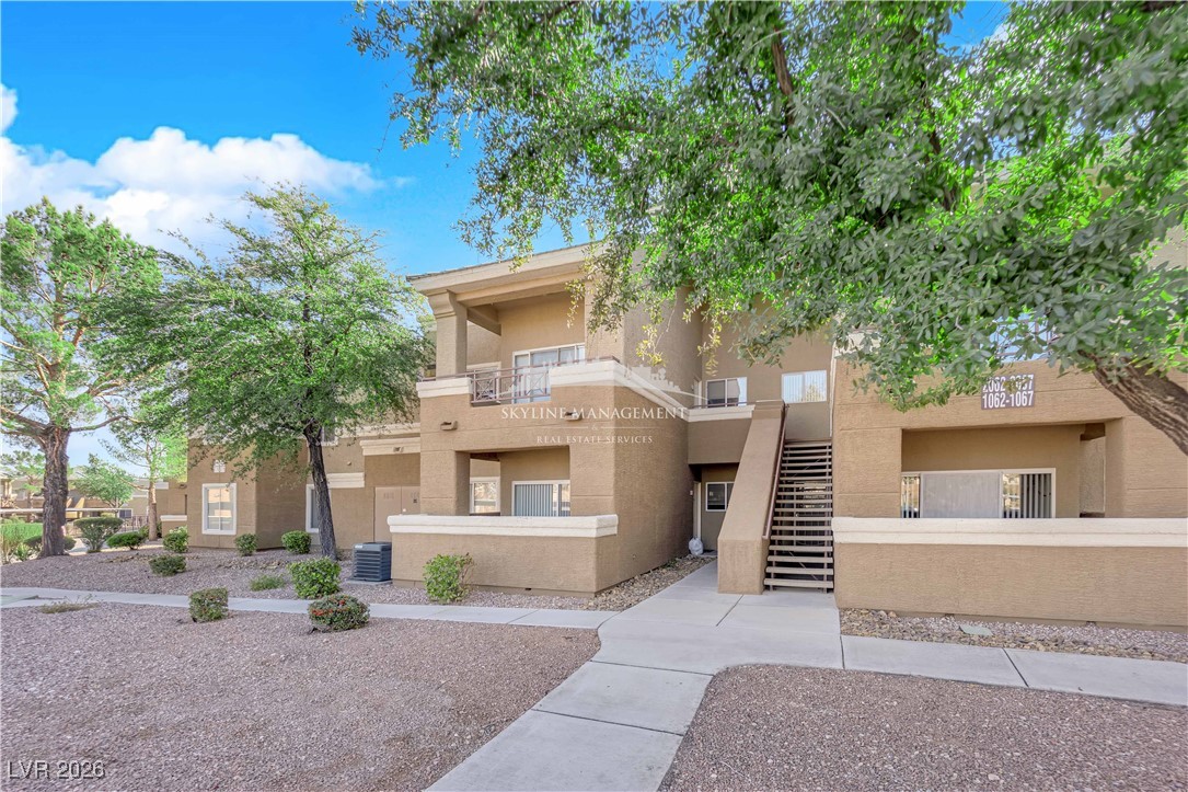8070 West Russell Road, Unit 2063 Las Vegas, NV 89113 - Photo 3 of 31 View of apartment building / complex featuring stairs