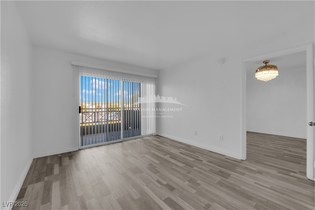8070 West Russell Road, Unit 2063 Las Vegas, NV 89113 - Photo 8 of 31 Unfurnished room featuring light wood finished floors and baseboards