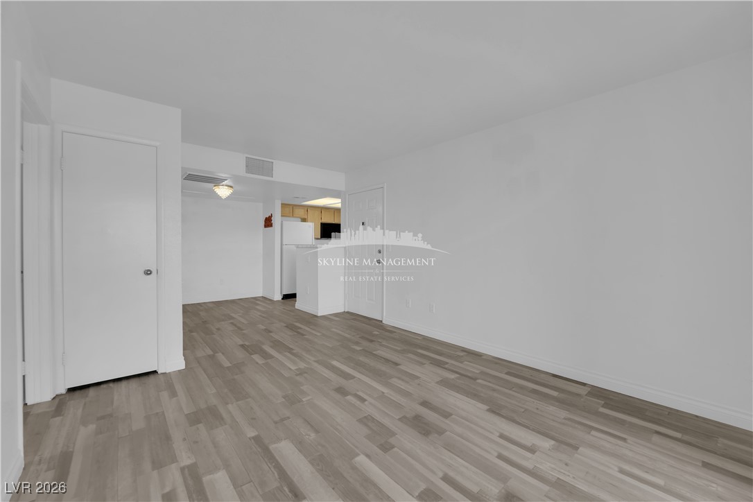 8070 West Russell Road, Unit 2063 Las Vegas, NV 89113 - Photo 10 of 31 Unfurnished living room with light wood finished floors