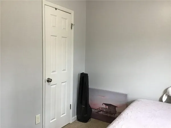 a bedroom with a bed and a chair