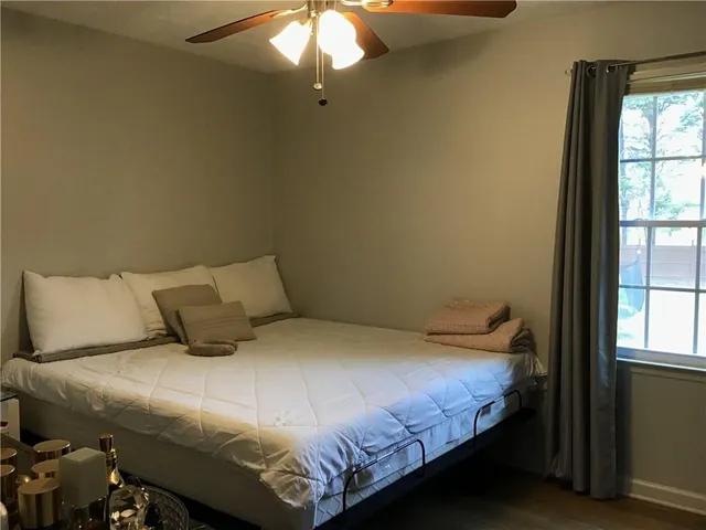 a bedroom with a bed and window