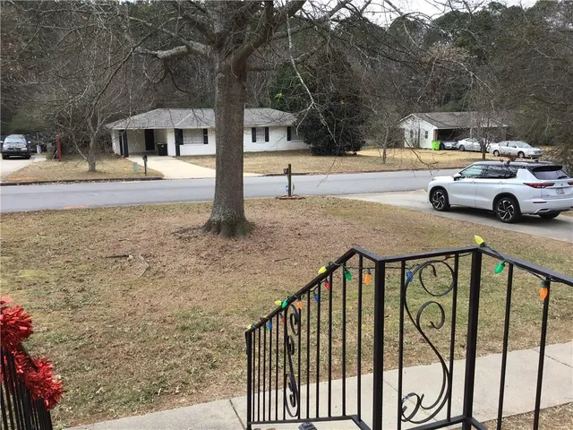 a view of a yard with car parked