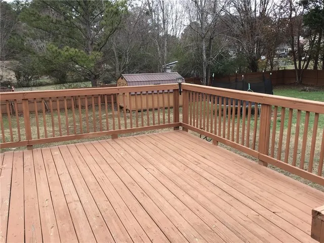 a view of backyard with a deck and wooden floor