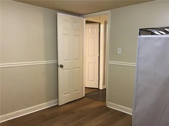 an empty room with wooden floor