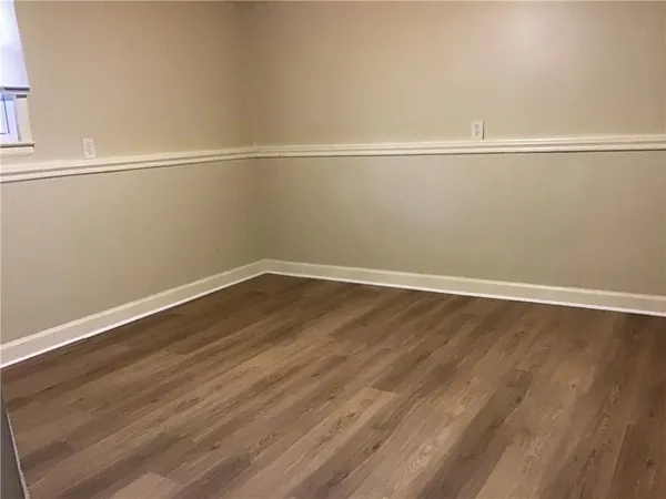 a view of a room with wooden floor