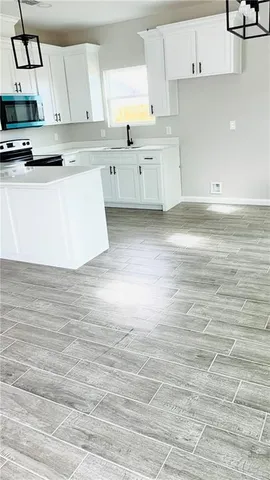 a kitchen with stainless steel appliances cabinets a sink and a stove