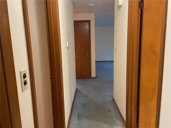 a view of a hallway to rooms