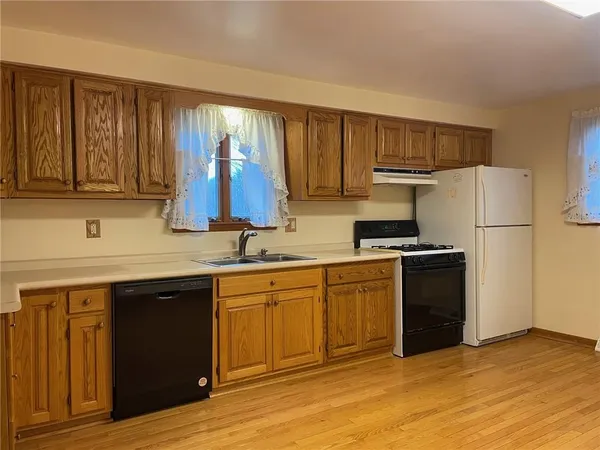 a kitchen with a sink cabinets and stainless steel appliances