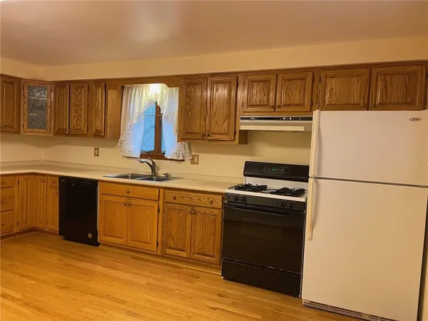 a kitchen with a sink stove and refrigerator