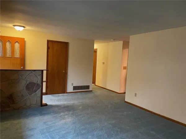 a view of an empty room with a fireplace