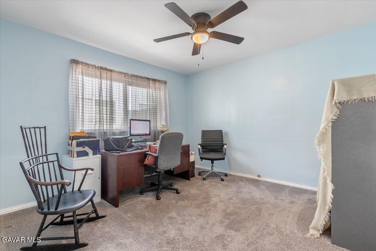 4817 Quartz Hill Road Quartz Hill, CA 93536 - Photo 16 of 41 a view of a workspace with furniture and a window