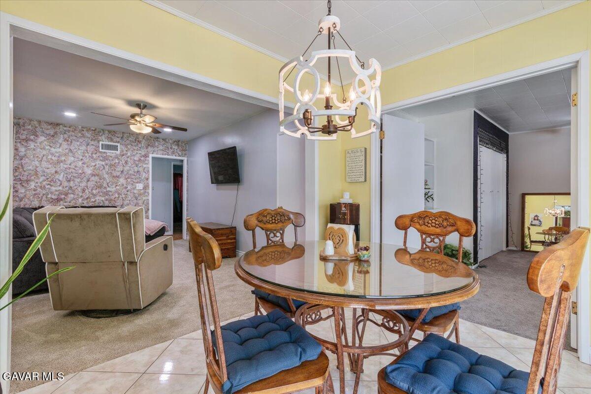 4817 Quartz Hill Road Quartz Hill, CA 93536 - Photo 18 of 41 a view of a dining room with furniture and chandelier