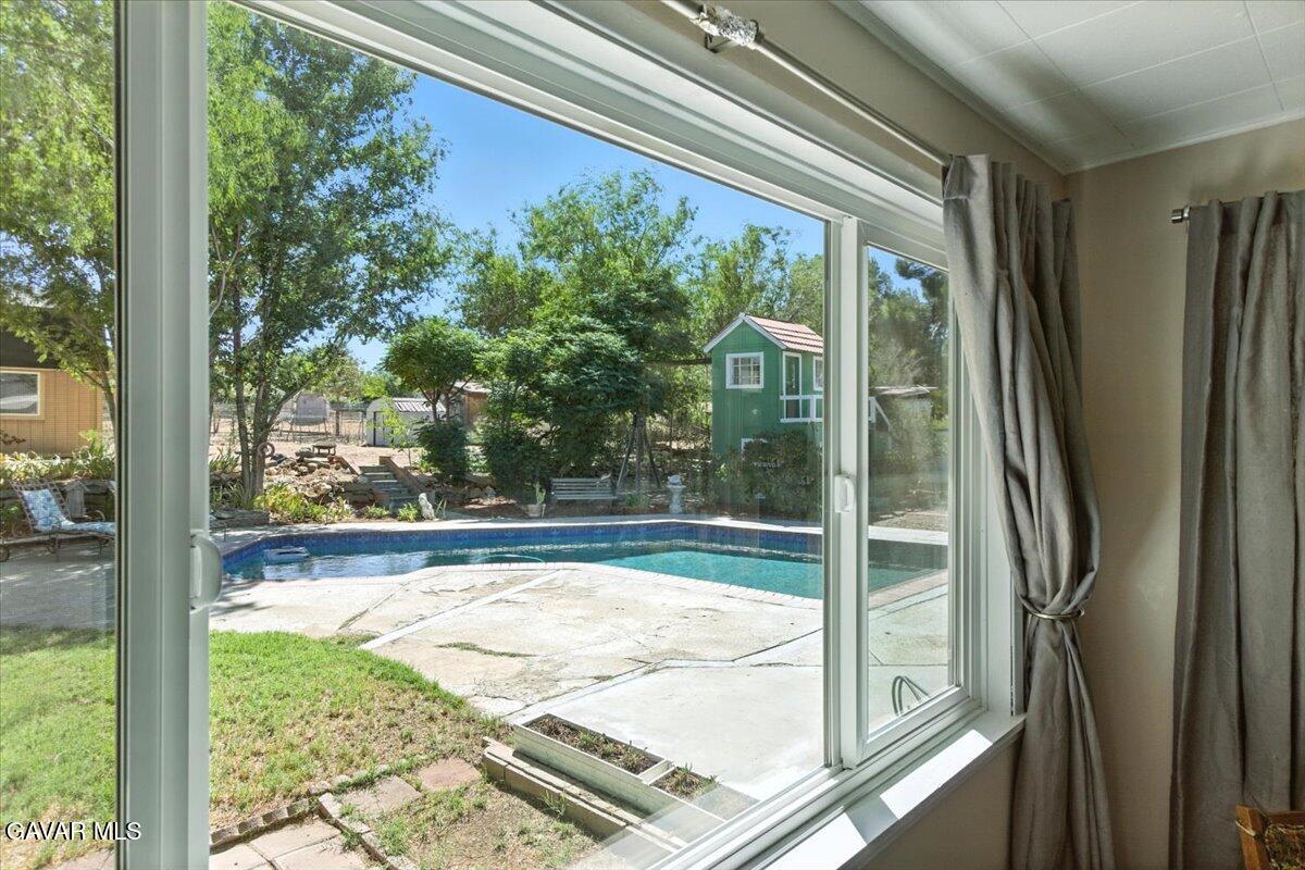 4817 Quartz Hill Road Quartz Hill, CA 93536 - Photo 5 of 41 a view of a room with a large window and wooden floor