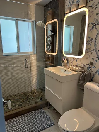 a bathroom with a toilet sink and shower
